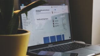 black and silver laptop computer beside yellow ceramic mug