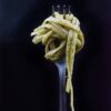 selective focus photography of fork with noodle